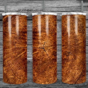 May include: Three stainless steel tumblers with a wood grain design. The tumblers are brown with a light brown wood grain pattern.