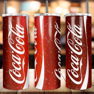 May include: Three stainless steel tumblers with lids and straws. Each tumbler features a red and white Coca-Cola design with condensation droplets.