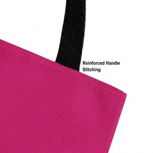 May include: A bright magenta tote bag featuring a black handle attached with reinforced handle stitching. The text Reinforced Handle Stitching is printed in black near the top edge of the bag, highlighting the durable construction of the strap.