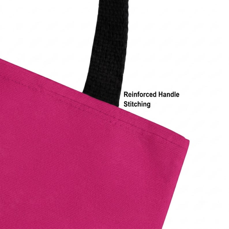 May include: A bright magenta tote bag featuring a black handle attached with reinforced handle stitching. The text Reinforced Handle Stitching is printed in black near the top edge of the bag, highlighting the durable construction of the strap.