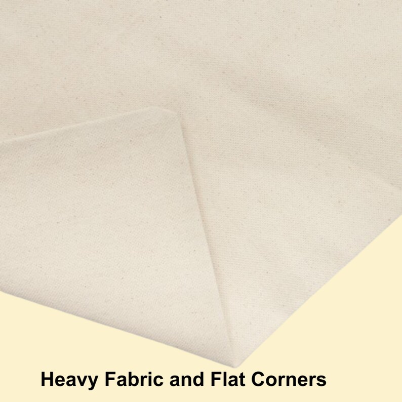 May include: A close-up view of off-white, heavy-weight canvas fabric featuring a folded corner that creates a sharp, flat edge. The material has a visible, dense weave texture throughout, and the text "Heavy Fabric and Flat Corners" is printed below.