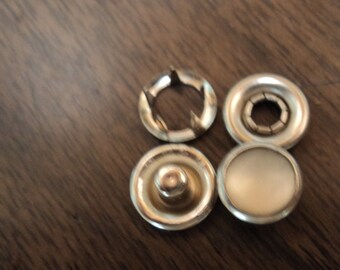 off-white western poly pearl snaps, size 16, 3/8" diameter.  1 dozen complete sets.  made in the usa