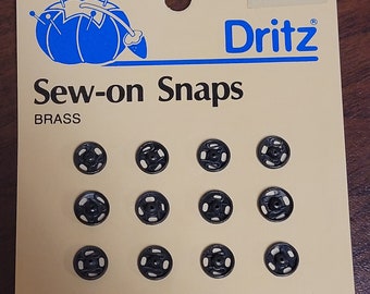 Dritz brass size 2/0 sew on snaps.  black.  12 sets.