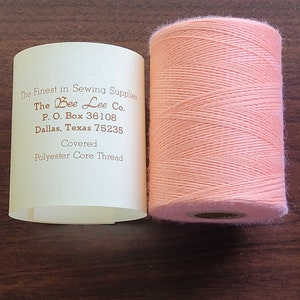 coral covered polyester thread.  2,000 yard spool.  made in the usa.
