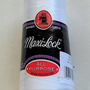May include: White serger thread spool with black and white label that says "Maxi-Lock" and "All Purpose Spun Polyester". The label also has a red sewing machine logo and a barcode.