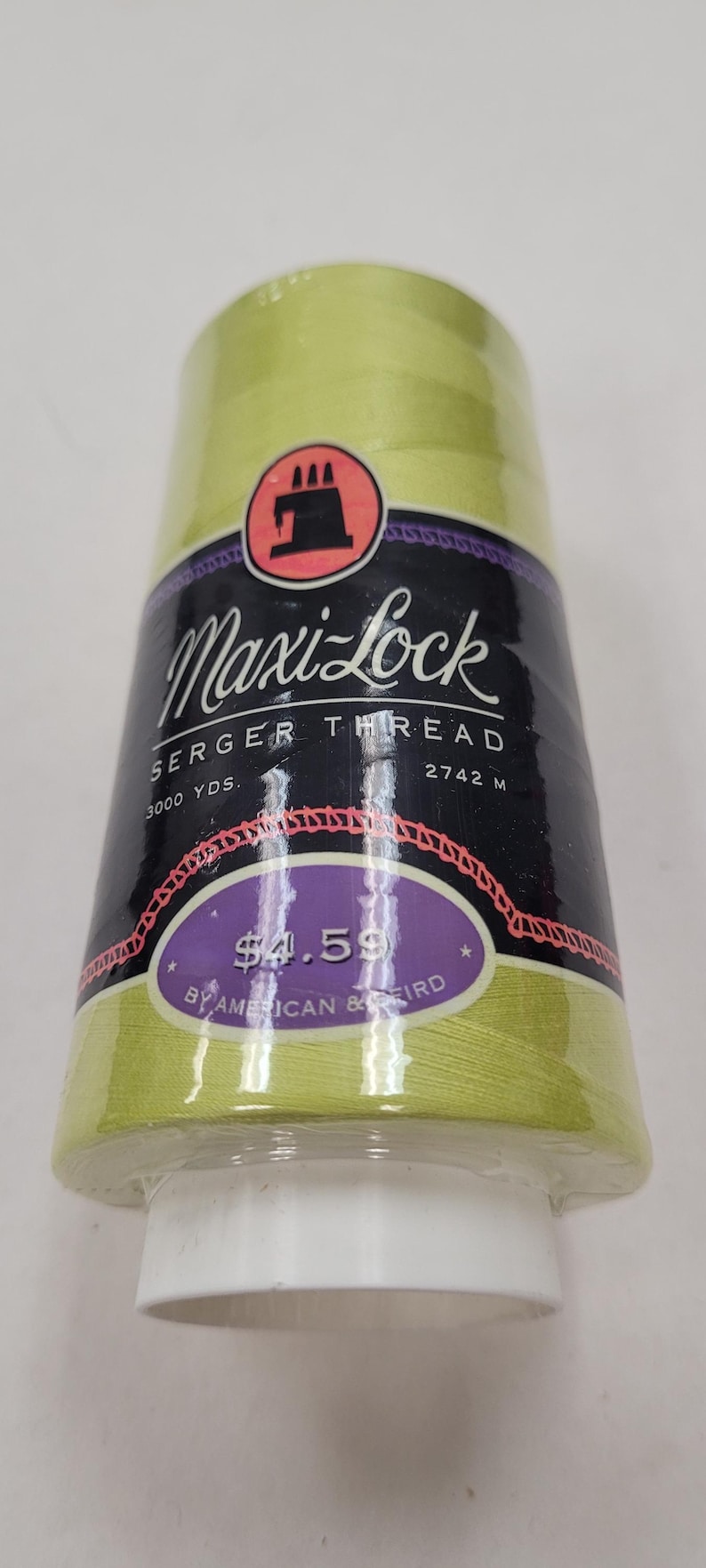 May include: A spool of Maxi-Lock serger thread in a light green color. The spool is labeled "Maxi-Lock Serger Thread" and has a price tag of $4.59. The spool is 3000 yards or 2742 meters.