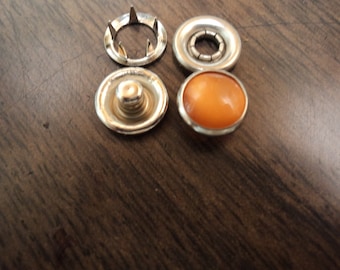 Orange western poly pearl snaps, size 16, 3/8" diameter.  1 dozen complete sets.  made in the usa