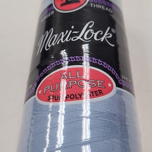 May include: A spool of light blue Maxi-Lock All Purpose Spun Polyester thread for sewing and serging.