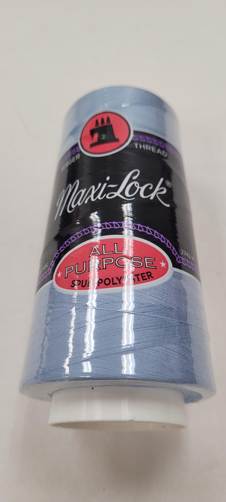 May include: A spool of light blue Maxi-Lock All Purpose Spun Polyester thread for sewing and serging.