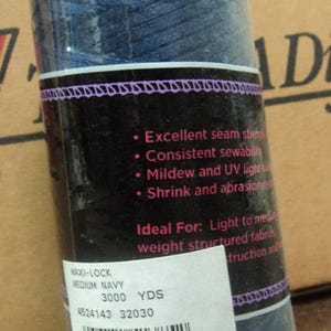 May include: A spool of Maxi-Lock medium navy blue thread. The label lists the thread as 3000 yards. Features include excellent seam strength, consistent sewability, mildew and UV light resistance, and shrink and abrasion resistance.