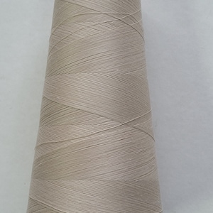100% spun polyester eggshell-tan, size 100-T21. 6000 yard cone.  made in the USA.
