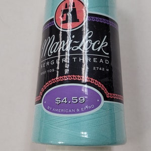 May include: A spool of turquoise blue serger thread by Mani-Lock. The label reads "Serger Thread" and "3000 yds. 2742 m". The price is $4.59. The label also says "By American & Efird."