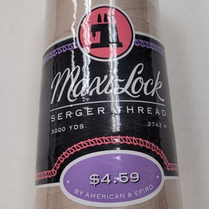 May include: A spool of beige Max Lock serger thread with a sewing machine icon on the label. The label also says "3000 yds. 2742 m" and "$4.59 by American & Efird".