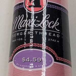 May include: A pink spool of serger thread by Mark Lock. The spool is labeled "Serger Thread" and has a price tag of $4.59. It is 3000 yards or 2742 meters long.