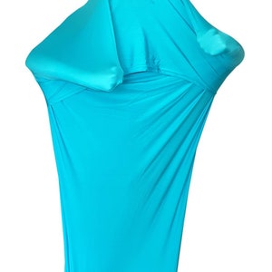 May include: A turquoise sensory sock, designed to provide deep pressure and proprioceptive input. The stretchy fabric conforms to the body, offering a calming and secure feeling. The sock is a vibrant shade of blue, and is designed to be used for therapeutic purposes.