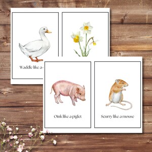 May include: Four watercolor animal prints on white backgrounds. The prints feature a white duck, daffodils, a pink piglet, and a brown mouse. Text includes "Waddle like a", "Oink like a piglet", and "Scurry like a mouse".
