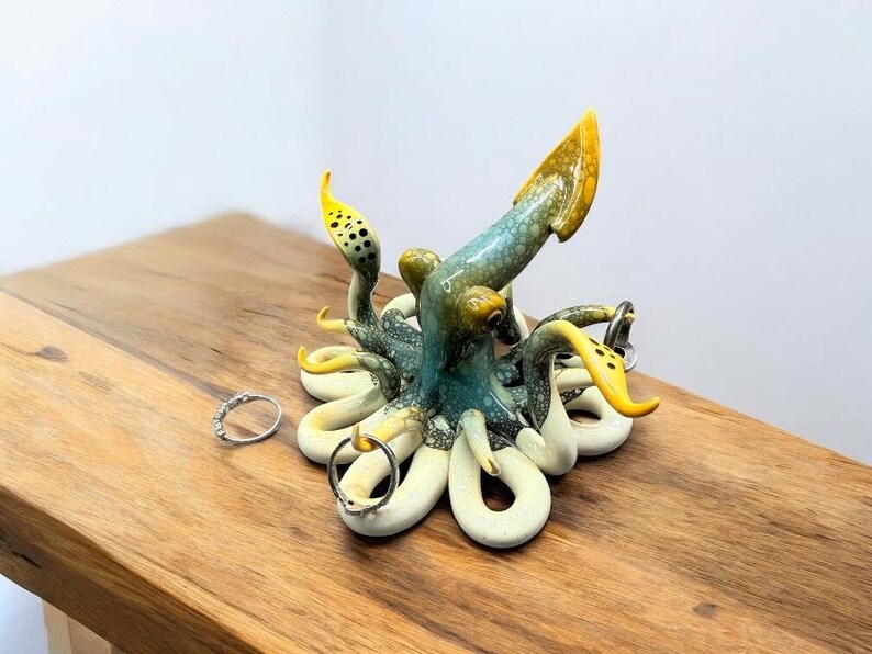 Handmade sculpted soft orange and baby blue, beige colored ceramic Squid jewelry ring holder perfect for gifts and sealife lovers