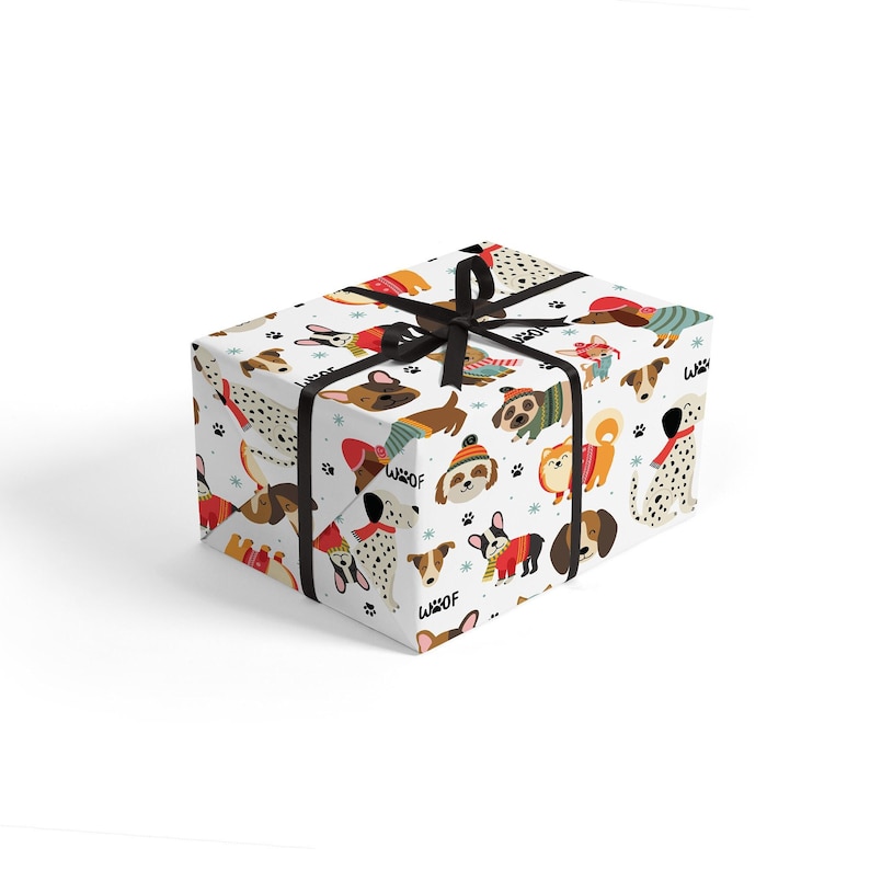 May include: A wrapped gift box featuring a white background with a repeating pattern of various dog breeds in sweaters and hats. The box is tied with a black ribbon. The word "Woof" is printed on the wrapping paper.