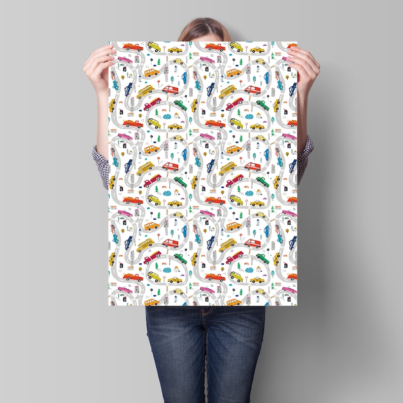 May include: A white background with a repeating pattern of colorful cars, trucks, and buses driving on winding roads. The pattern includes traffic lights, trees, and clouds.