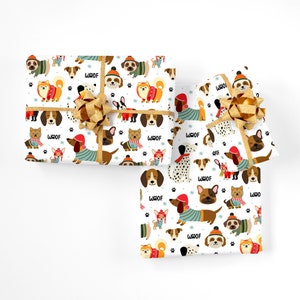 May include: Three wrapped gifts with a white background. The wrapping paper features a repeating pattern of various dog breeds wearing winter clothing and hats, with the word "WOOF" and paw prints. The gifts are tied with gold ribbon and bows.