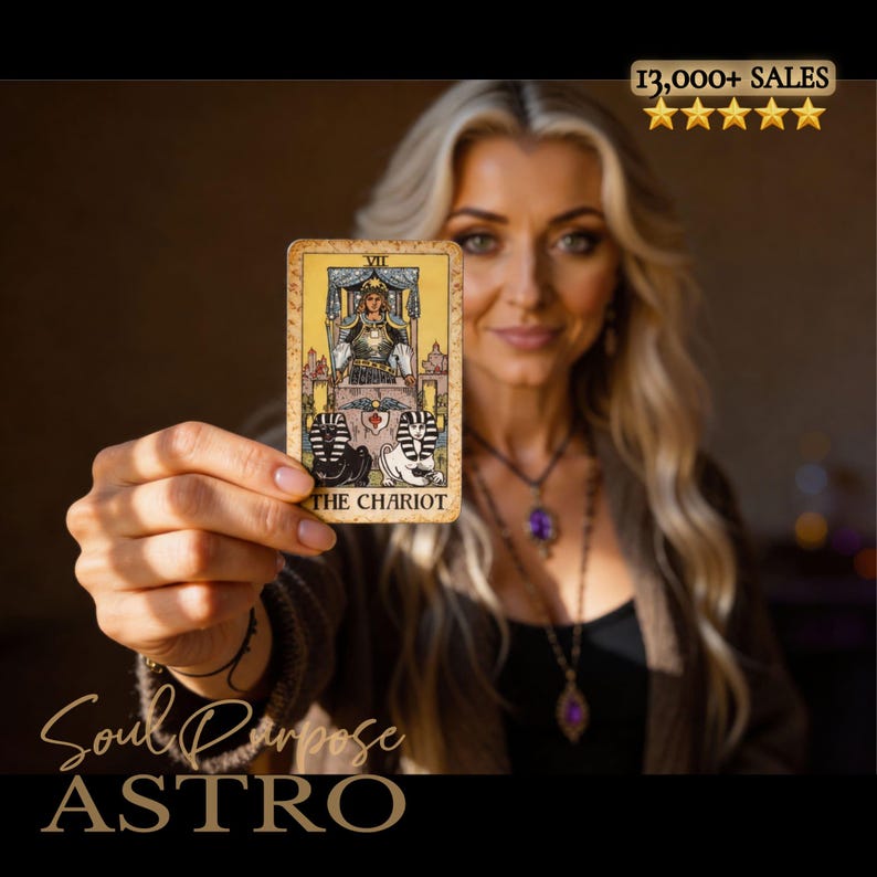 May include: A rectangular tarot card titled The Chariot featuring a figure in armor seated in a chariot pulled by two sphinxes, one black and one white. The card has a yellow background with ornate borders and the Roman numeral VII at the top.
