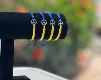 Ukrainian flag bracelet. Peace charm and Ukrainian colors. Handmade bracelet. Stand with Ukraine.