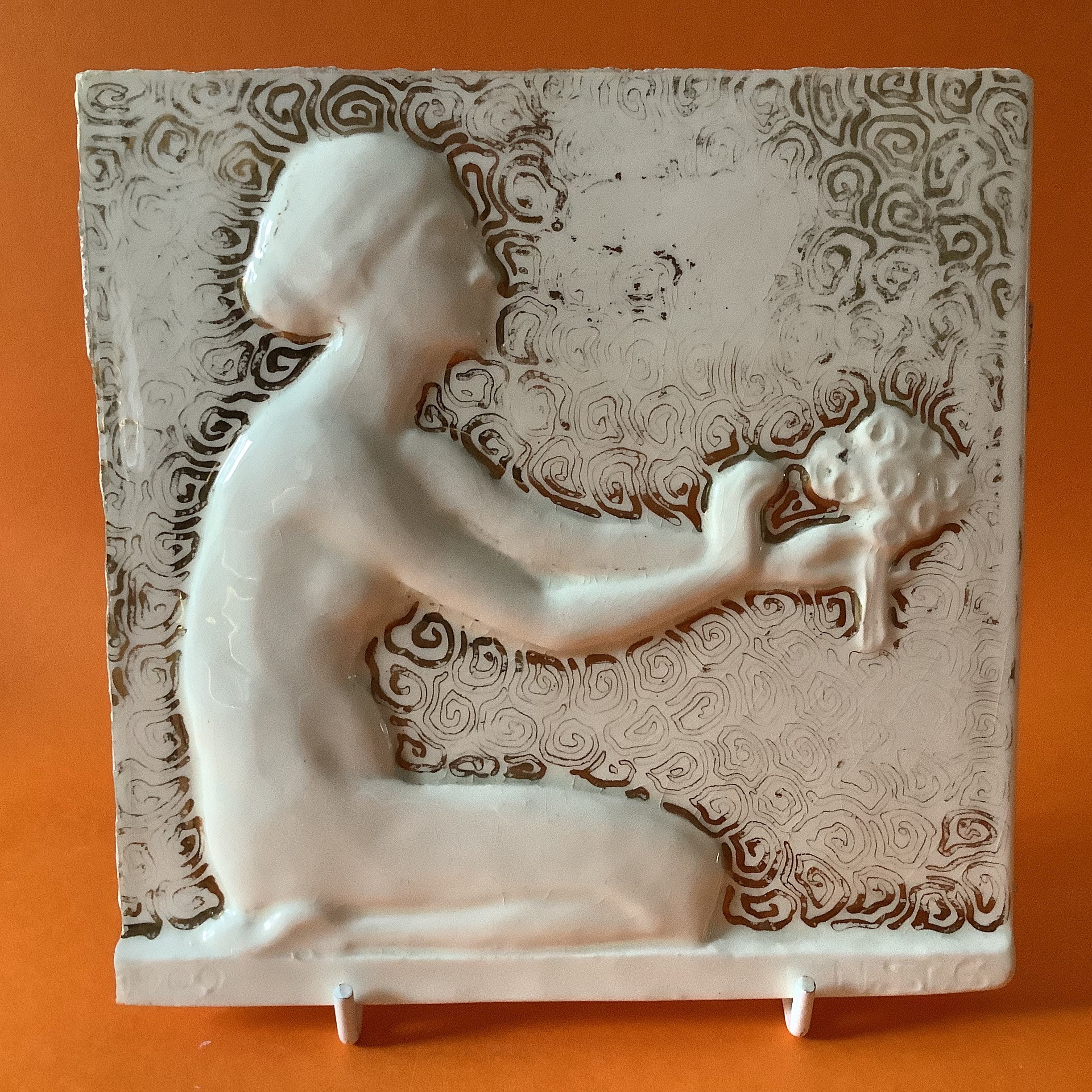Art Nouveau Tile of a Nude Woman holding a bouquet of flowers.