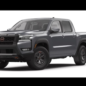 May include: A gray pickup truck with black accents and black wheels. The truck has a four-door cab and a truck bed. The front of the truck features a black grille and headlights. The truck is on a white background.