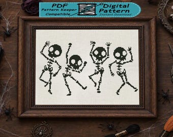 May include: A cross stitch pattern featuring four black skeletons in various dancing poses on a white fabric background, enclosed in a dark brown wooden frame. The top of the image includes a blue banner with the text PDF Pattern Keeper Compatible.