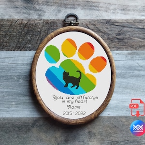 May include: Rainbow paw print cross stitch pattern with a black cat silhouette and the text "You are always in my heart Name 2015-2022".