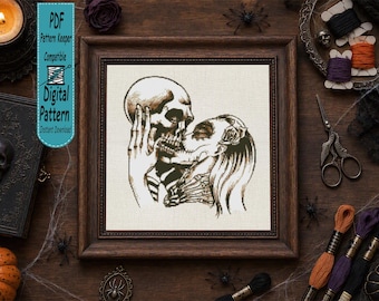 Op de afbeelding: Een kruissteekpatroon met een donkere illustratie van een skelet dat een schedel vasthoudt en een figuur met een skeletgezicht kust. Het ontwerp is ingelijst in een donkere houten lijst en bevat de tekst PDF Pattern Keeper Compatible DIGITAL PATTERN.
