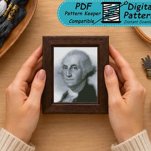 May include: A cross-stitch pattern featuring a grayscale portrait of George Washington inside a dark brown wooden frame. The image includes a blue digital badge with the text PDF Pattern Keeper Compatible Digital Pattern Instant Download.