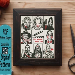 May include: A framed cross-stitch pattern featuring a grid of nine horror movie characters and a central clapperboard with the text IT'S HORROR MOVIE TIME. The design uses black, white, and red thread to depict iconic figures in a detailed, stitched style.