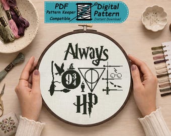 May include: A circular wooden embroidery hoop containing a black cross-stitch design on white fabric. The pattern features the word Always, the number 9 3/4, the Deathly Hallows symbol, and the letters HP, surrounded by various small magical icons.