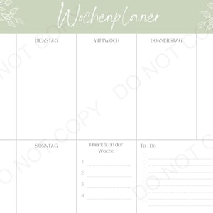 May include: A weekly planner with a green background and white floral accents. The planner is divided into seven sections for each day of the week, with a section for prioritizing tasks and a to-do list.