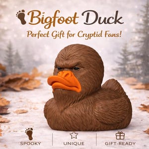 May include: A brown Bigfoot Duck figurine with an orange beak. The text "Bigfoot Duck" is displayed above the duck. The background includes pine cones, leaves, and a forest scene. The text "Perfect Gift for Cryptid Fans!" is also displayed.