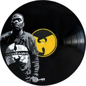 May include: A black vinyl record featuring a yellow Wu-Tang Clan logo and a black and white image of Method Man.
