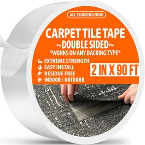 May include: A roll of white carpet tile tape with an orange label. The label reads "CARPET TILE TAPE ~DOUBLE SIDED~ *WORKS ON ANY BACKING TYPE*" and lists features like "EXTREME STRENGTH" and "INDOOR/OUTDOOR". The tape is 2 inches wide and 90 feet long.