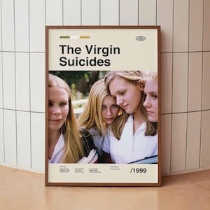 May include: A framed poster for the film "The Virgin Suicides" with a photograph of four young women with blonde hair. The poster has a cream background with the title in black and the year 1999.