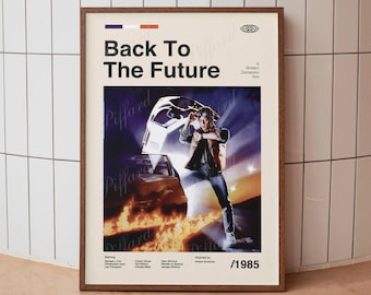 May include: A framed poster featuring the title Back To The Future in bold black text. The central image shows a person standing before a car with open doors, surrounded by flames. The poster includes the year 1985 and cast credits.