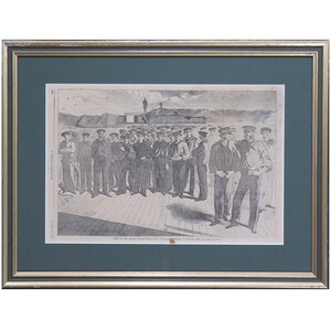 May include: Framed black and white print showing a group of men in naval uniforms on a ship deck. The print is in a gold and green frame, with text at the bottom.
