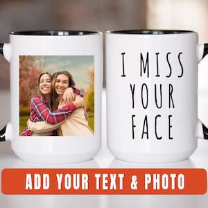 May include: White ceramic mug with a black rim and handle. The mug features a photo of two women hugging on one side and the text "I miss your face" on the other side.