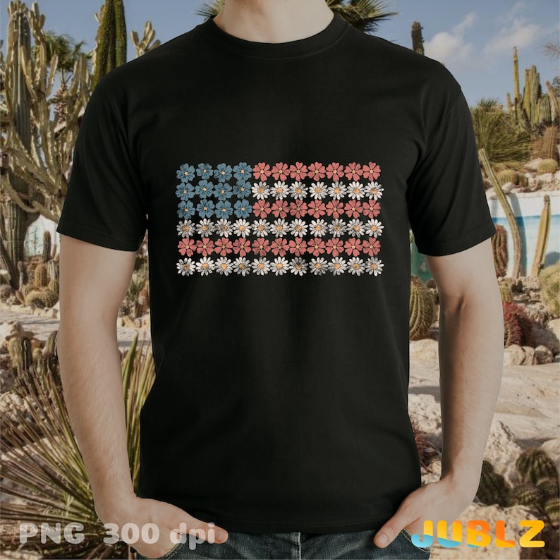May include: A black t-shirt with a floral design that resembles the American flag. The flowers are red, white, and blue.