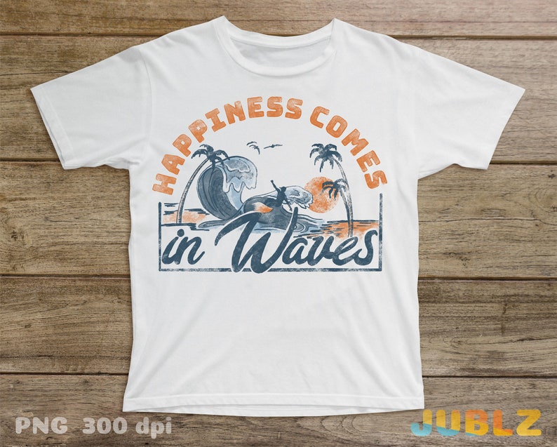 May include: White t-shirt with a vintage-style graphic design. The graphic features a surfer riding a wave with palm trees and a sunset in the background. The text "Happiness Comes in Waves" is printed in a distressed font.
