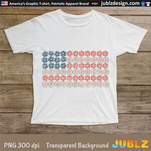 May include: A white t-shirt with a graphic of an American flag made of flowers. The flowers are red, white, and blue. The background is transparent.