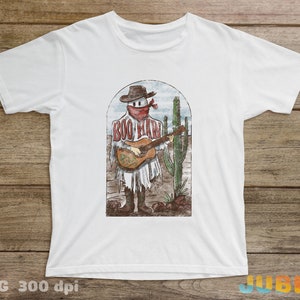 May include: White t-shirt with a graphic of a cartoon ghost wearing a cowboy hat and bandana, playing a guitar, with the text "Boo-Haw" on the shirt. The ghost is standing in front of a cactus.