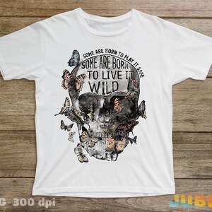May include: White t-shirt with a black and white skull graphic with butterflies and the text "Some are born to play it safe. Some are born to live it wild."