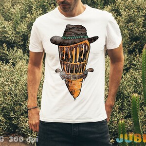 May include: White t-shirt with a graphic of a carrot wearing a cowboy hat and the text "Easter Cowboy".