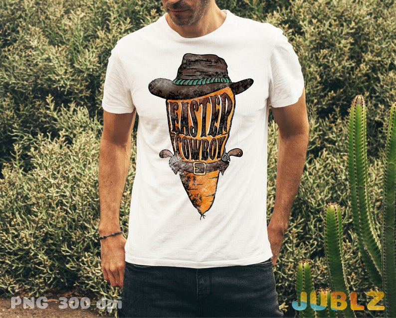May include: White t-shirt with a graphic of a carrot wearing a cowboy hat and the text "Easter Cowboy".