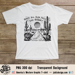 May include: A white t-shirt with a black and white graphic design of a desert landscape with cacti and a road. The text "WHEN ALL ELSE FAILS GOD DOESN'T" is written in a circle around a sun. The text "PSALMS 73:26" is written below the graphic.